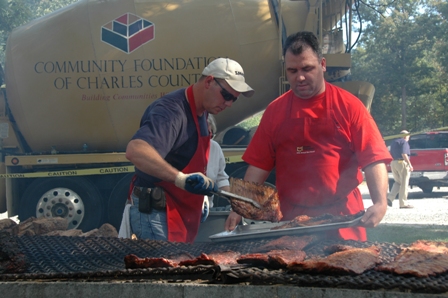 Will Robertson and Robert Tyrrell pull a rack of ribs from the pit